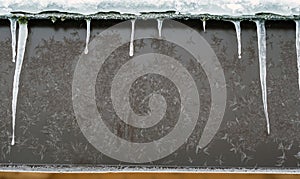 Frozen roof background with icicle and snowflakes