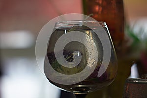 frozen rose in water glass cup with restaurant background