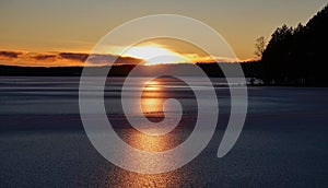 Frozen Runn lake near Falun in Sweden at sunset