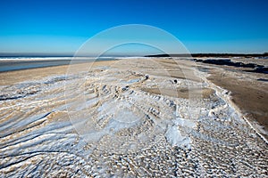 frozen sand textures in winter by the sea beach