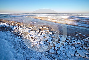 Frozen sea during sunset. Beautiful blue colored natural seascape in the winter time