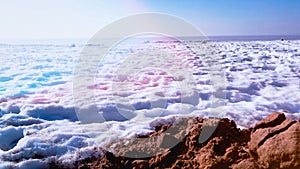 Frozen sea and textured snow on sand beach. Winter nature background with copy space. Sunny day on seaside. Springtime
