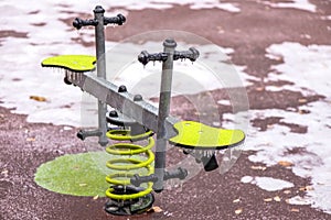 Frozen seesaw outdoors in a playground photo