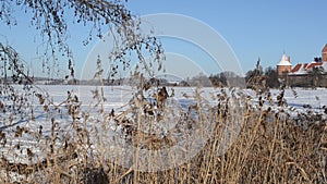 Frozen ship lake people tourists recreate castle Trakai