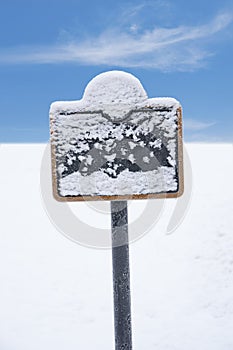Frozen sign covered in snow photo