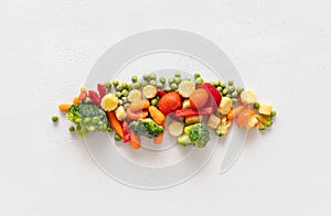 Frozen sliced vegetables on a white background. Frozen food concept. Top view, flat lay