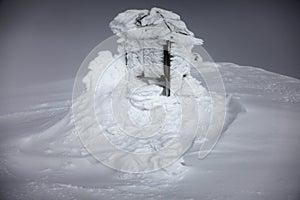 Frozen snow covering an old meteo station in Svalbard photo