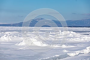 Frozen snow dusted Lake baikal in winter khuzhir island in foreground