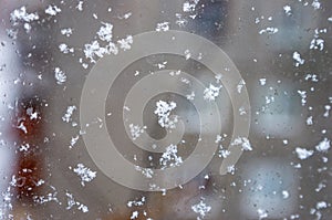 frozen snowflakes on the glass of the house, the first snow, cold snap