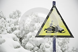 Frozen snowmobile sign and fogy, snowy background