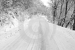 Frozen snowy road with ice ahead
