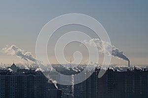 Frozen snowy winter air with smoke over city