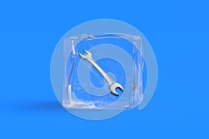 Frozen spanner in ice cube.
