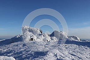 Frozen stones in the middle of nowhere with wonderful and clear sky. Top of the highest mountain in Low Tatras Dumbier. View on