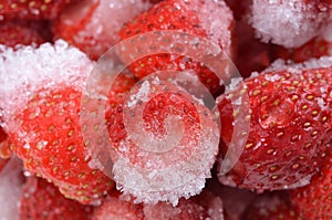 Frozen strawberries with ice crystals background