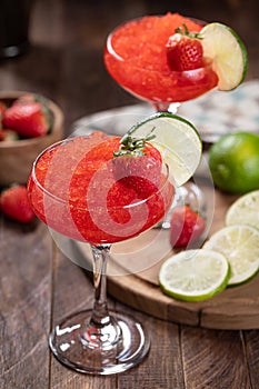 Frozen strawberry daiquiri cocktail with strawberries and lime
