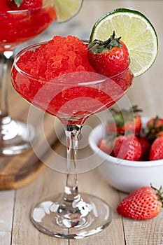 Frozen strawberry daiquiri cocktail with strawberries and lime