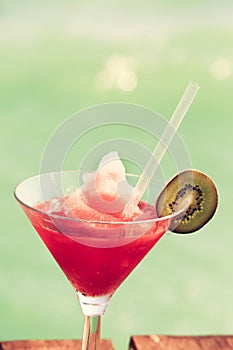 Frozen Strawberry Daiquiri cocktail on the wooden pier. Concept