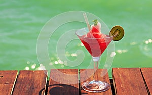 Frozen Strawberry Daiquiri cocktail on the wooden pier. Concept