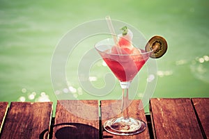 Frozen Strawberry Daiquiri cocktail on the wooden pier. Concept