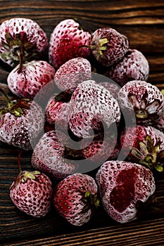 Frozen strawberry from fridge,summer harvest covered by ice, sweet fresh ripe berry, healthy vitamin fruit food. top view, flat