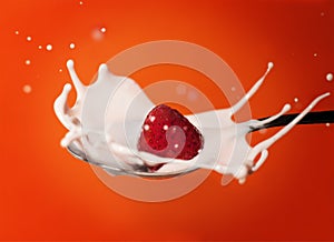Frozen strawberry splashing into yoghurt