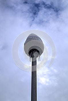 Frozen street light with icicles in cold winter day