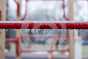 Frozen swing with icicles, playground, horizontal bars