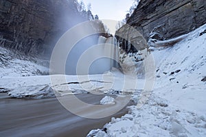 Frozen Taughannock Falls in winter, surrounded by ice along gorge trail, Taughannock Falls State Park, Ulysses, New York