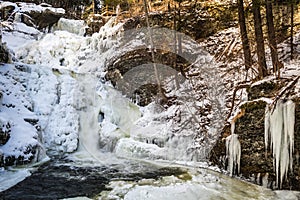 Frozen tiered waterfall covered in beautiful ice formations