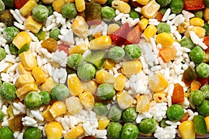 Frozen vegetable mix with rice as background,