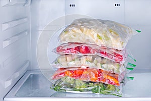 Frozen vegetables in bags in refrigerator