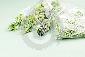 Frozen vegetables, close-up. Green peas and broccoli in transparent bags. proper defrosting of vegetables