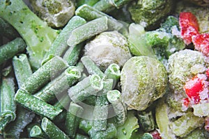 Frozen vegetables close up. Vegetables in the fridge. Ice on vegetables.