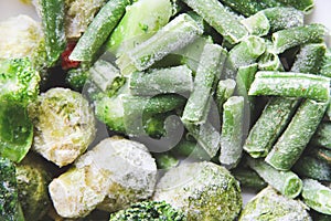 Frozen vegetables close up. Vegetables in the fridge. Ice on vegetables.
