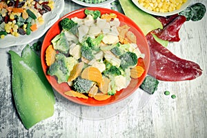 Frozen vegetables in plate and bowl