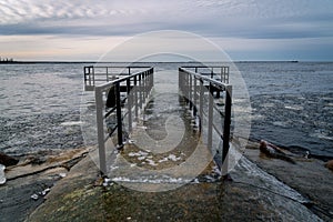 Frozen watching platform on the Mangalsala or Eastern pier in Riga, Latvia where the river Daugava flows into the Baltic Sea