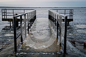 Frozen watching platform on the Mangalsala or Eastern pier in Riga, Latvia where the river Daugava flows into the Baltic Sea