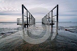 Frozen watching platform on the Mangalsala or Eastern pier in Riga, Latvia where the river Daugava flows into the Baltic Sea