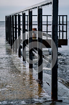 Frozen watching platform on the Mangalsala or Eastern pier in Riga, Latvia where the river Daugava flows into the Baltic Sea