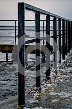 Frozen watching platform on the Mangalsala or Eastern pier in Riga, Latvia where the river Daugava flows into the Baltic Sea