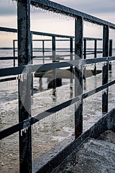 Frozen watching platform on the Mangalsala or Eastern pier in Riga, Latvia where the river Daugava flows into the Baltic Sea
