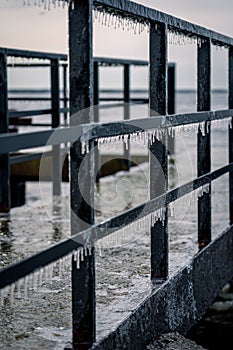 Frozen watching platform on the Mangalsala or Eastern pier in Riga, Latvia where the river Daugava flows into the Baltic Sea