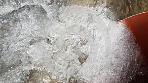 Frozen water flows and ice drops closeup