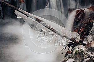 Frozen Water Ice on a Branch above the Creek