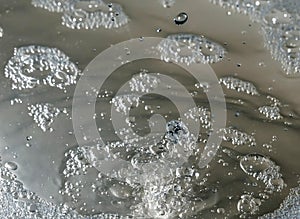 Frozen water splashes over the surface with bubbles. Texture of water