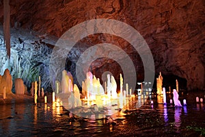 Frozen water Stalagmite in deep marble cave, Russia