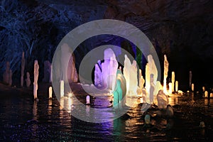 Frozen water Stalagmite in deep marble cave, Russia