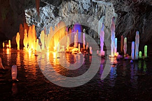 Frozen water Stalagmite in deep marble cave, Russia