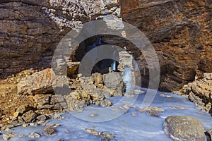 Frozen waterfall in a gorge high in the mountains